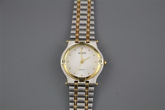 A modern stainless steel and yellow metal Gucci quartz dress wristwatch, on steel and yellow metal bracelet,